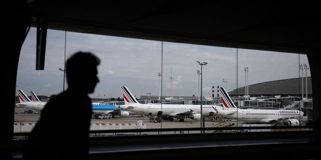 A traveler walks through the corridors of Terminal 2 at Roissy-Charles de Gaulle Airport in the north-eastern suburbs of Paris on September 16, 2022. 