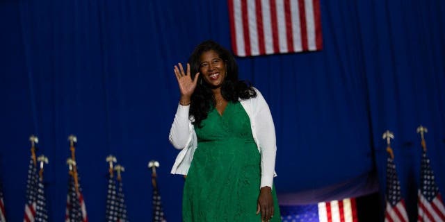 Republican nominee for Secretary of State Kristina Karamo waves to the crowd before speaking at a Save America rally on October 1, 2022 in Warren, Michigan.