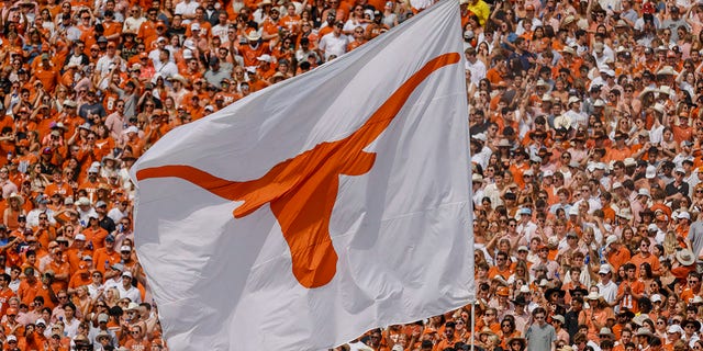 The Texas Longhorns flag flies after a touchdown during a game between Texas and the Oklahoma Sooners Oct. 8, 2022, at the Cotton Bowl in Dallas. 