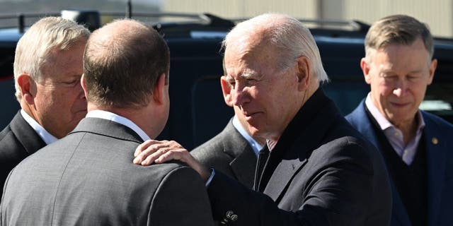 U.S. President Joe Biden speaks with Colorado Governor Jared Polis after disembarking Air Force One at Eagle County Regional Airport in Gypsum, Colorado on October 12, 2022.