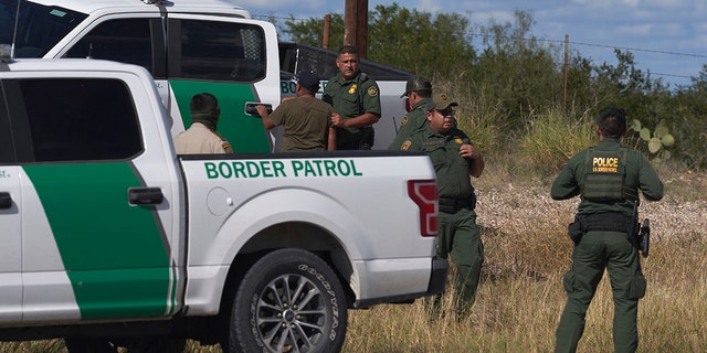 An illegal migrant found smuggled in a vehicle is apprehended by U.S. Border Patrol and the Webb County Sheriff on October 12, 2022, in Laredo, Texas. 