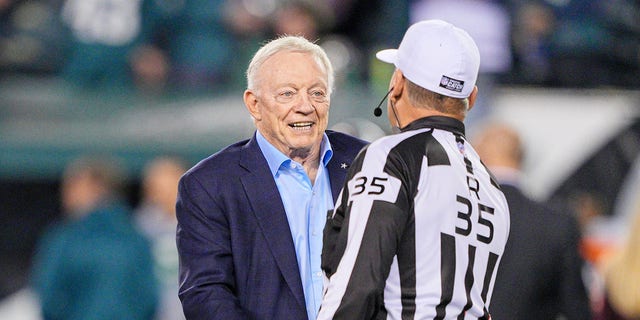 Dallas Cowboys owner Jerry Jones chats with referee John Hussey, #35, during the game between the Dallas Cowboys and the Philadelphia Eagles on Oct. 16, 2022 at Lincoln Financial Field in Philadelphia.