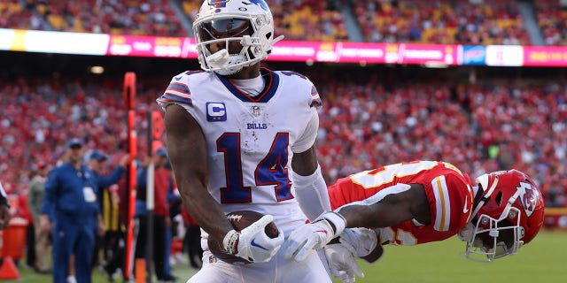 Buffalo Bills wide receiver Stefon Diggs (14) hauls in a 17-yard touchdown catch over Kansas City Chiefs cornerback Joshua Williams (23) in the third quarter of a game Oct. 16, 2022, at GEHA Field at Arrowhead Stadium in Kansas City, Mo. 