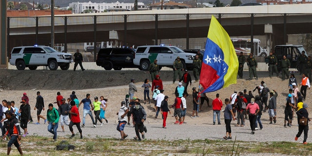 Venezuelan migrants flee from the Border Patrol agents of the El Paso sector during a demonstration against U.S. immigration policies in Ciudad Juarez, Mexico, on October 31, 2022.