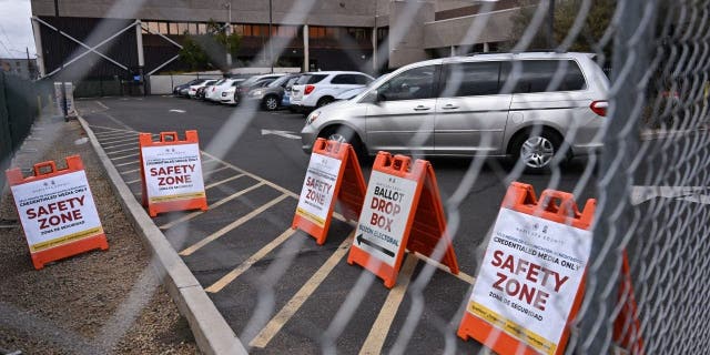 A media safety zone is seen behind fencing surrounding the outside of the Maricopa County Tabulation and Election Center ahead of the Arizona midterm elections in Phoenix on Nov. 3, 2022. 