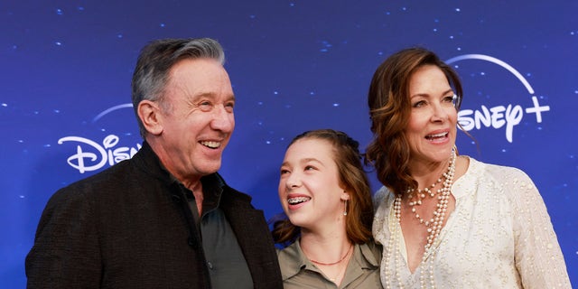 Tim Allen poses with his daughter, Elizabeth Allen-Dick, and his wife, Jane Hajduk, on the red carpet.