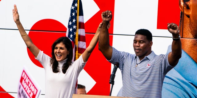 Herschel Walker and American Diplomat Nikki Haley during his Unite Georgia Bus Tour rally at Pirate Printing in Hiram, Ga., on Sunday, November 6, 2022.