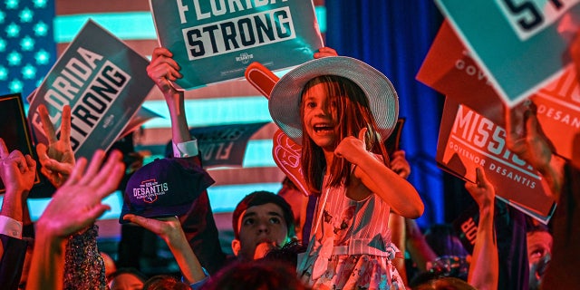 Supporters of Republican gubernatorial candidate for Florida Ron DeSantis cheer during an election night watch party at the Convention Center in Tampa, Florida, on November 8, 2022. - Florida Governor Ron DeSantis, who has been tipped as a possible 2024 presidential candidate, was projected as one of the early winners of the night in Tuesday's midterm election. 