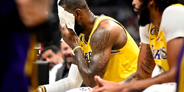 LeBron James of the Lakers wipes his face during the LA Clippers game at the Crypto.com Arena in Los Angeles on Wednesday, Nov. 9, 2022.
