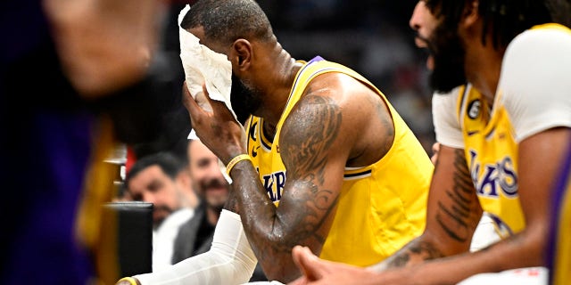LeBron James of the Lakers wipes his face during the LA Clippers game at the Crypto.com Arena in Los Angeles on Wednesday, Nov. 9, 2022.