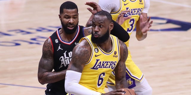 Lakers forward LeBron James spins on LA Clippers forward Marcus Morris Sr. on Nov. 9, 2022, at Crypto.com Arena in Los Angeles.