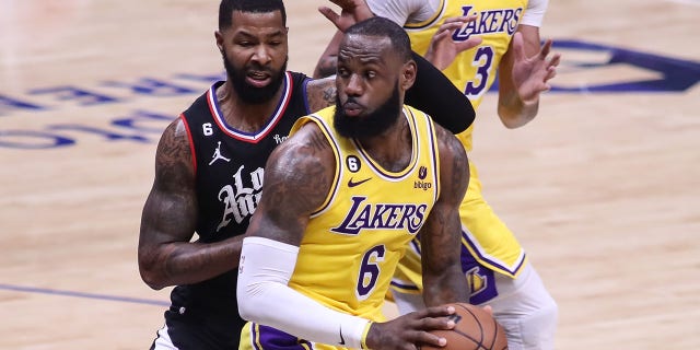 Lakers forward LeBron James spins on LA Clippers forward Marcus Morris Sr. on Nov. 9, 2022, at Crypto.com Arena in Los Angeles.