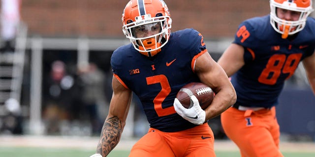 Illinois Fighting Illini running back Chase Brown (2) advances the ball during a game against the Purdue Boilermakers Nov. 12, 2022, at Memorial Stadium in Champaign, Ill.