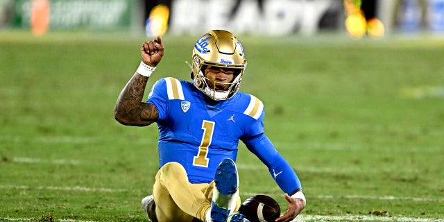 Quarterback Dorian Thompson-Robinson of the UCLA Bruins points toward the end zone against the Arizona Wildcats in the first half of a game at the Rose Bowl in Pasadena Nov. 12, 2022.