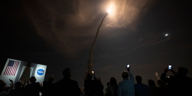 Guests watch the launch of NASAs Space Launch System rocket carrying the Orion spacecraft on the Artemis I flight test, from Launch Complex 39B on November 16, 2022, at the Kennedy Space Center, Florida. 