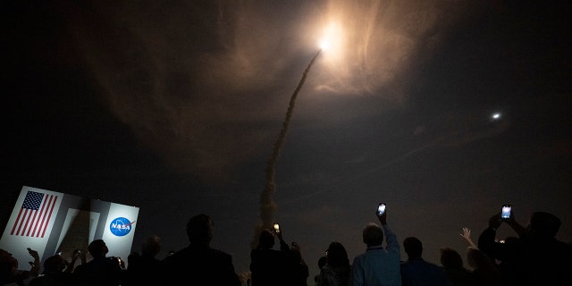Guests watch the launch of NASAs Space Launch System rocket carrying the Orion spacecraft on the Artemis I flight test, from Launch Complex 39B on November 16, 2022, at the Kennedy Space Center, Florida.