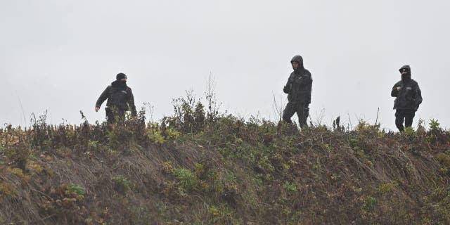 Members of the Police searching the fields near the village of Przewodow in the Lublin Voivodeship, seen on Nov. 16, 2022, in Przewodow, Poland.