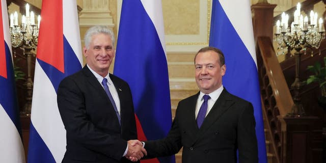 Deputy head of Russia's Security Council, Dmitry Medvedev, right, shakes hands with Cuban President Miguel Diaz-Canel during their meeting at the Gorki state residence outside Moscow on Nov. 21, 2022. (Yekaterina Shtukina/Sputnik/AFP via Getty Images)
