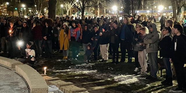 People hold candles during a vigil at Acacia Park for the victims of a mass shooting at Club Q, an LGBTQ nightclub, at Acacia Park in Colorado Springs, Colorado, on Nov. 21, 2022.