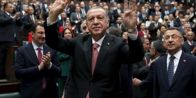 Turkish President and Justice and Development Party leader Recep Tayyip Erdogan is greeted by members of his party before addressing the Turkish Grand National Assembly in Ankara November 23, 2022.