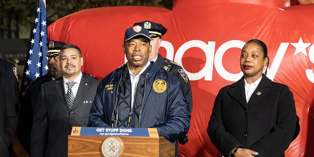 Mayor Eric Adams, center, with Police Commissioner Keechant Sewell and Macy's CEO Jeff Gennette, makes a safety-related announcement for the Thanksgiving Day Parade on 77th Street. 