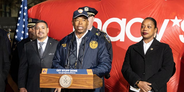 Mayor Eric Adams, center, with Police Commissioner Keechant Sewell and Macy's CEO Jeff Gennette, makes a safety-related announcement for the Thanksgiving Day Parade on 77th Street. 