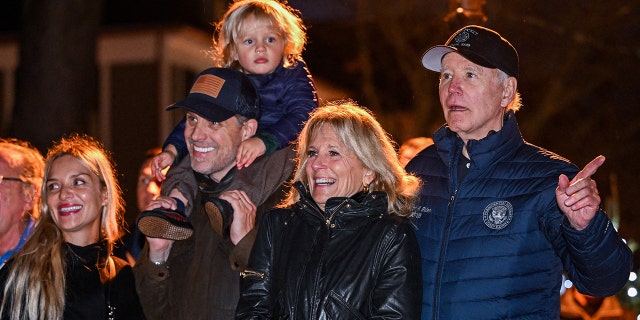 US President Joe Biden watches a Christmas tree lighting ceremony with (R-L) First Lady Jill Biden, son Hunter Biden, grandson Beau, and daughter-in-law Melissa Cohen in Nantucket, Massachusetts, on November 25, 2022.