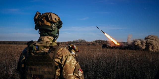 A Ukrainian soldier watches a self-propelled 220 mm multiple rocket launcher "Bureviy" firing towards Russian positions on the front line, eastern Ukraine on Nov. 29, 2022, amid the Russian invasion of Ukraine. 