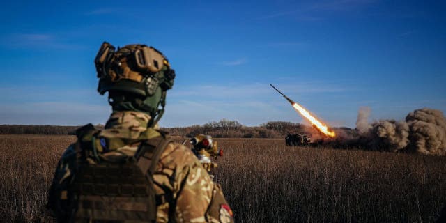 A Ukrainian soldier watches a self-propelled 220 mm multiple rocket launcher "Bureviy" firing towards Russian positions on the front line, eastern Ukraine on Nov. 29, 2022, amid the Russian invasion of Ukraine.