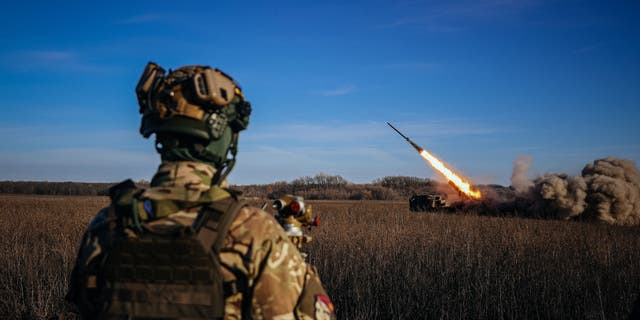 A Ukrainian soldier watches a self-propelled 220 mm multiple rocket launcher "Bureviy" firing towards Russian positions on the front line, eastern Ukraine on Nov. 29, 2022, amid the Russian invasion of Ukraine. 