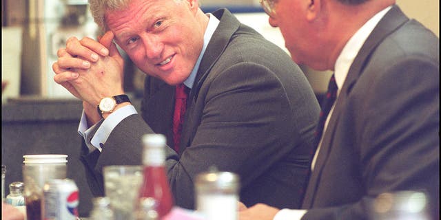 President Bill Clinton chats with Mayor Tom Menino at Mike's City Diner before consuming a plate of eggs, ham and oatmeal, January 18, 2000. Boston Herald staff photo by Matt Stone.