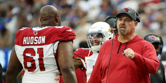 Offensive line coach Sean Kugler of the Arizona Cardinals fist bumps Rodney Hudson #61 after a play during the fourth quarter against the Los Angeles Rams at SoFi Stadium on October 03, 2021 in Inglewood, California. 