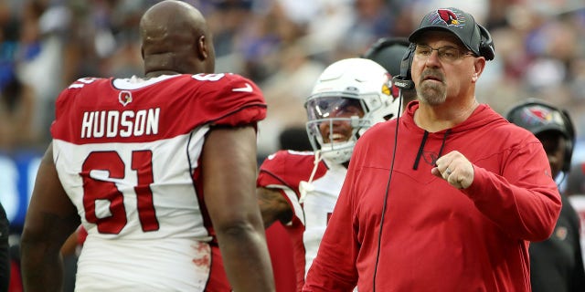 Offensive line coach Sean Kugler of the Arizona Cardinals fist bumps Rodney Hudson #61 after a play during the fourth quarter against the Los Angeles Rams at SoFi Stadium on October 03, 2021 in Inglewood, California.