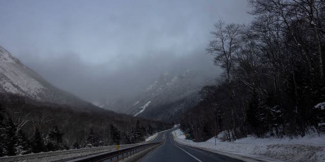 Fog hangs over the narrow trail through Franconia Notch on December 27, 2021 in the White Mountain National Forest in New Hampshire.