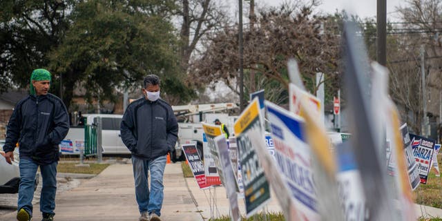 People walk to cast their ballot at the Moody Community Center on Feb.  24, 2022, in Houston.