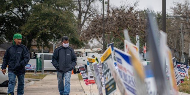 People walk to cast their ballot at the Moody Community Center on Feb. 24, 2022, in Houston.