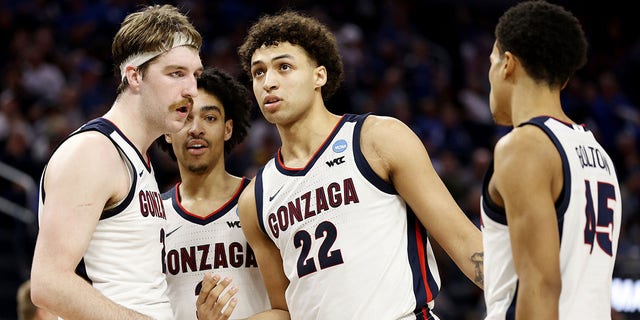 Anton Watson (22) of the Gonzaga Bulldogs talks with Drew Timme (2), Andrew Nembhard (3) and Rasir Bolton (45) against the Arkansas Razorbacks during the second half in the Sweet 16 of the 2022 NCAA men's basketball tournament at Chase Center March 24, 2022, in San Francisco. 