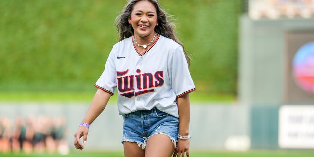 Olympic gymnast Suni Lee throws the first pitch before a game between the Minnesota Twins and the Toronto Blue Jays on August 5, 2022, at Target Field in Minneapolis.