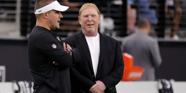 Head coach Josh McDaniels (left) and owner and managing general partner Mark Davis of the Las Vegas Raiders talk ahead of a preseason game against the New England Patriots at Allegiant Stadium.  December 26, 2022 in Las Vegas.