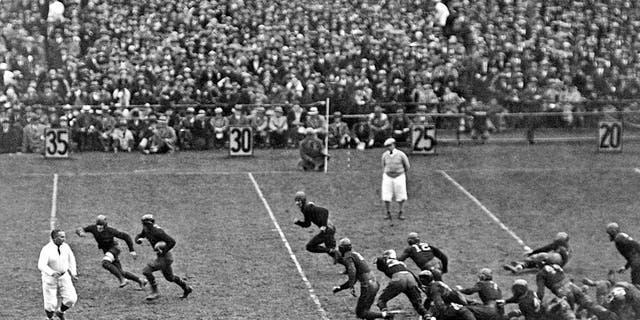 Notre Dame's Jack Chevigny rushes for 25 yards in the game against Army at Yankee Stadium in New York on November 10, 1928. Earlier, Knute Rockne gave his famous, "Win one for the Gipper" speech – and when Chevigny later scored a touchdown to tie the game, he said, "It's one for the Gipper." Notre Dame won 12-6.  Chevigny was killed on Iwo Jima during World War II.