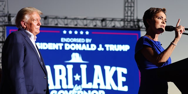 Former US President Donald Trump and Arizona Republican Kari Lake during a campaign rally at Legacy Sports USA on October 09, 2022 in Mesa, Arizona. 