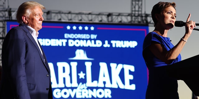 Former US President Donald Trump and Arizona Republican Kari Lake during a campaign rally at Legacy Sports USA on October 09, 2022 in Mesa, Arizona. 