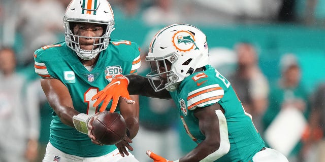 Tua Tagovailoa, #1 of the Miami Dolphins, hands the shot to Chase Edmonds, #2, during the 3rd 4th against the Pittsburgh Steelers astatine Hard Rock Stadium connected Oct. 23, 2022 successful Miami Gardens, Florida.