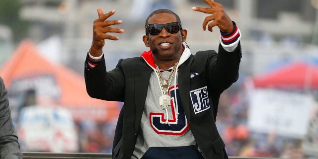 Coach Deion Prime Sanders speaks to ESPN commentators before the Jackson State Tigers and Southern University Jaguars NCAA Division I Football Championship Subdivision game at Mississippi Veterans Memorial Stadium on October 29, 2022, in Jackson.