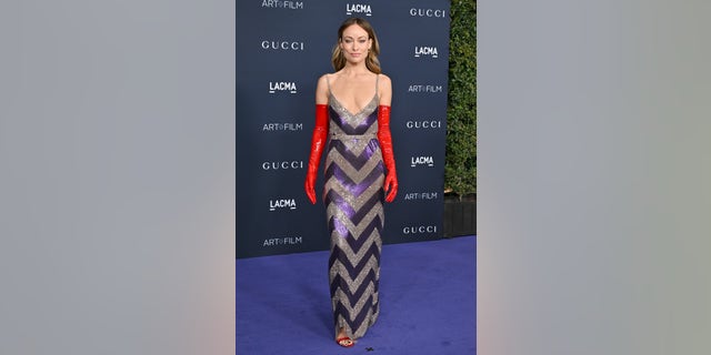 Olivia Wilde's look was bolstered by the addition of long red gloves.
