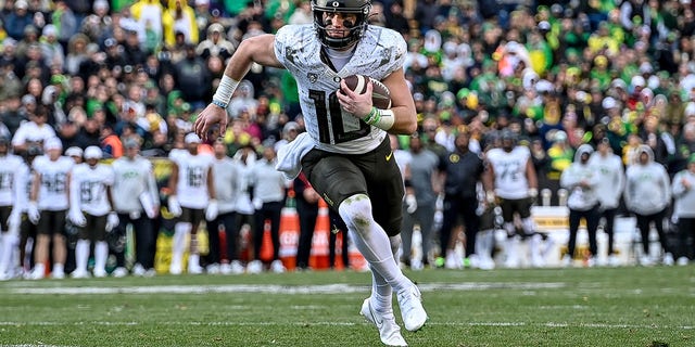 Quarterback Bo Nix of the Oregon Ducks carries the ball for a fourth quarter touchdown against the Colorado Buffaloes at Folsom Field Nov. 5, 2022, in Boulder, Colo. 