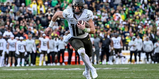 Quarterback Bo Nix of the Oregon Ducks carries the ball for a fourth quarter touchdown against the Colorado Buffaloes at Folsom Field Nov. 5, 2022, in Boulder, Colo. 