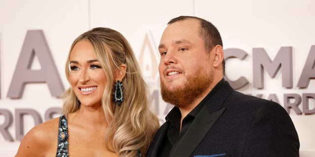 Nicole Hocking Combs and Luke Combs arrive at the 2022 CMA Awards red carpet. Combs took home the CMA Award in the Album of the Year category for "Growin' Up" and Entertainer of the Year.