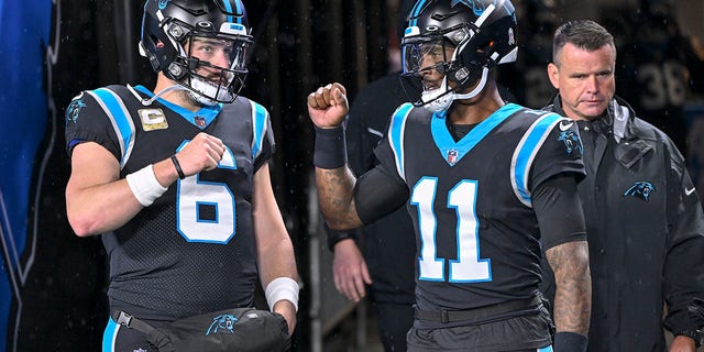 Baker Mayfield, #6 of the Carolina Panthers, and PJ Walker, #11 of the Carolina Panthers, talk before their game against the Atlanta Falcons at Bank of America Stadium on Nov. 10, 2022 in Charlotte, North Carolina. 