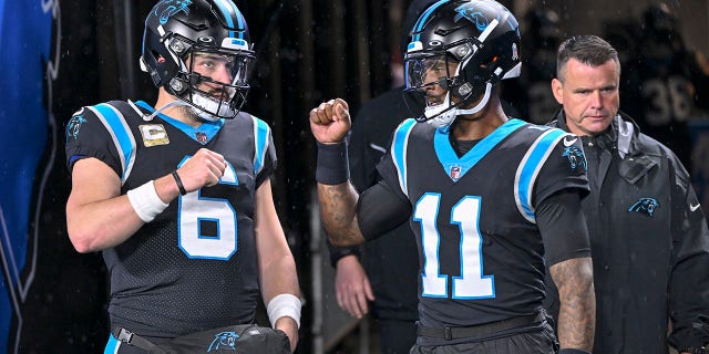 Carolina Panthers number 6 Baker Mayfield and Carolina Panthers number 11 PJ Walker speak before their game against the Atlanta Falcons at Bank of America Stadium on November 10, 2022 in Charlotte, North Carolina. 